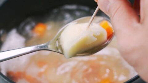 Testing boiled potatoes for doneness.