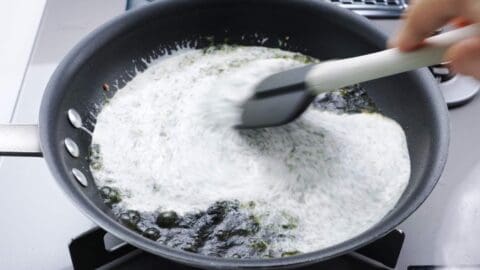 Stirring cream into nori for Japanese pasta.