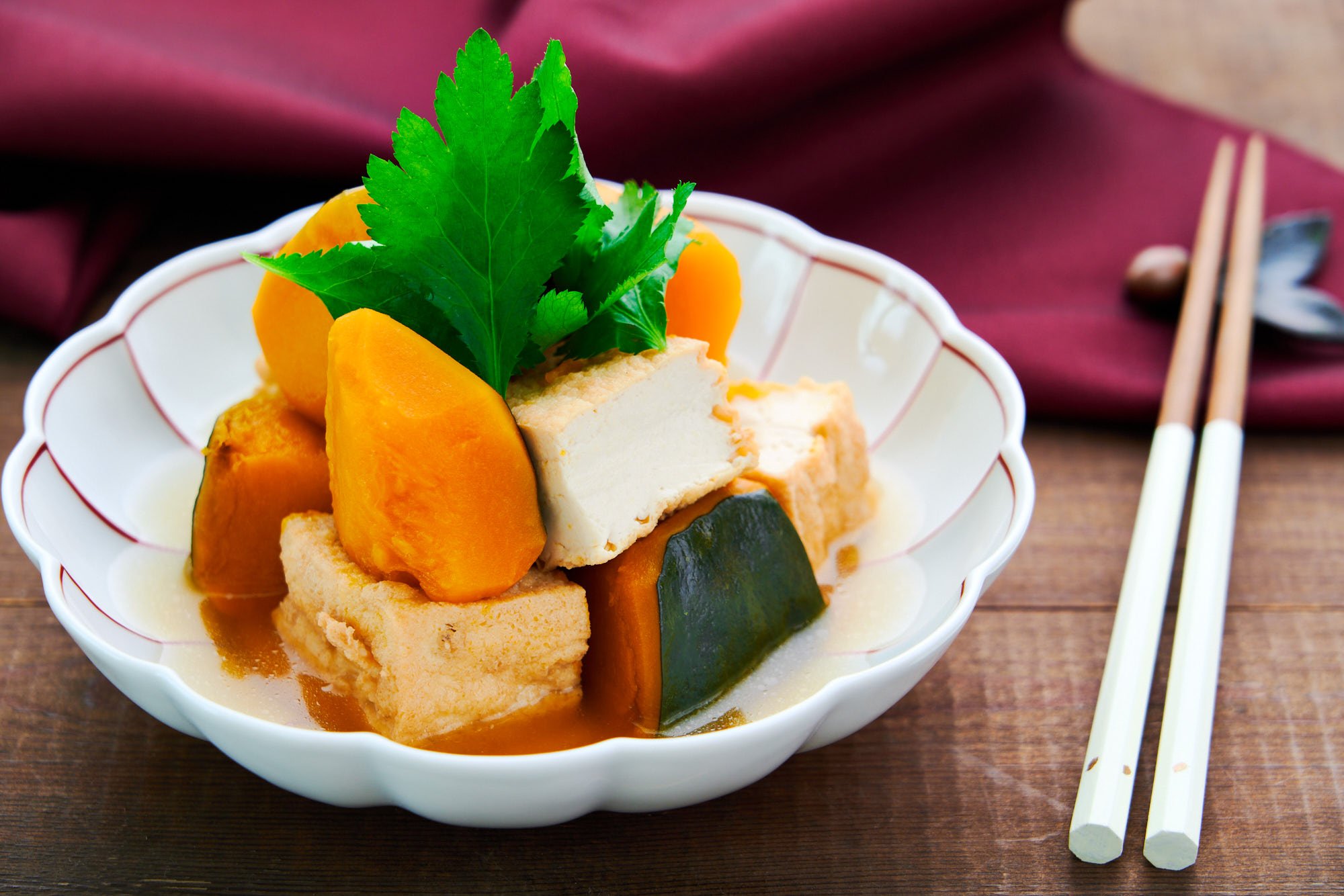 Sweet creamy kabocha pumpkin and atsuage tofu simmered in dashi stock garnished with mitsuba leaves.