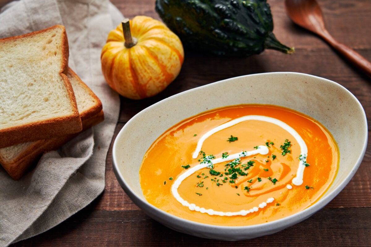 This vibrant orange bowl of Kabocha squash soup tastes like autumn in a bowl.