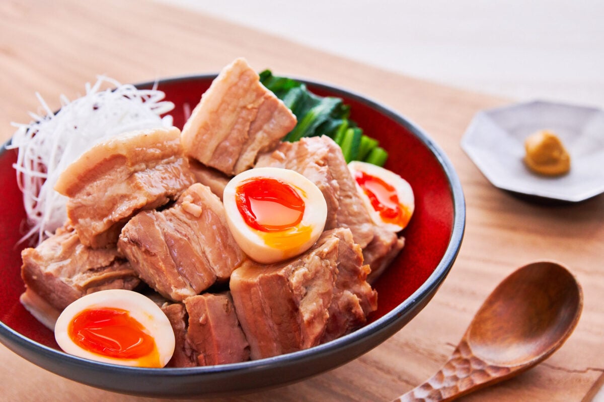 Kakuni is a Japanese dish that's made with cubes of pork belly that are braised with aromatics until fall-apart tender. As a bonus, you can make ramen eggs by soaking soft-boiled eggs in the braising liquid.