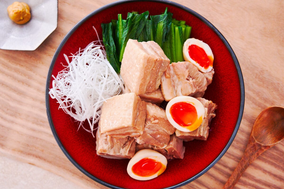 Kakuni is a Japanese classic made by braising pork belly in aromatics until fall-apart tender. The braising liquid can then be used to make marinated ramen eggs.