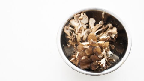 Maitake mushrooms tossed with olive oil, salt and pepper, ready to be roasted.