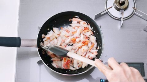 Crab meat and scallions being sauteed.