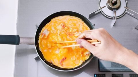 Crab meat and egg omelette in a frying pan.