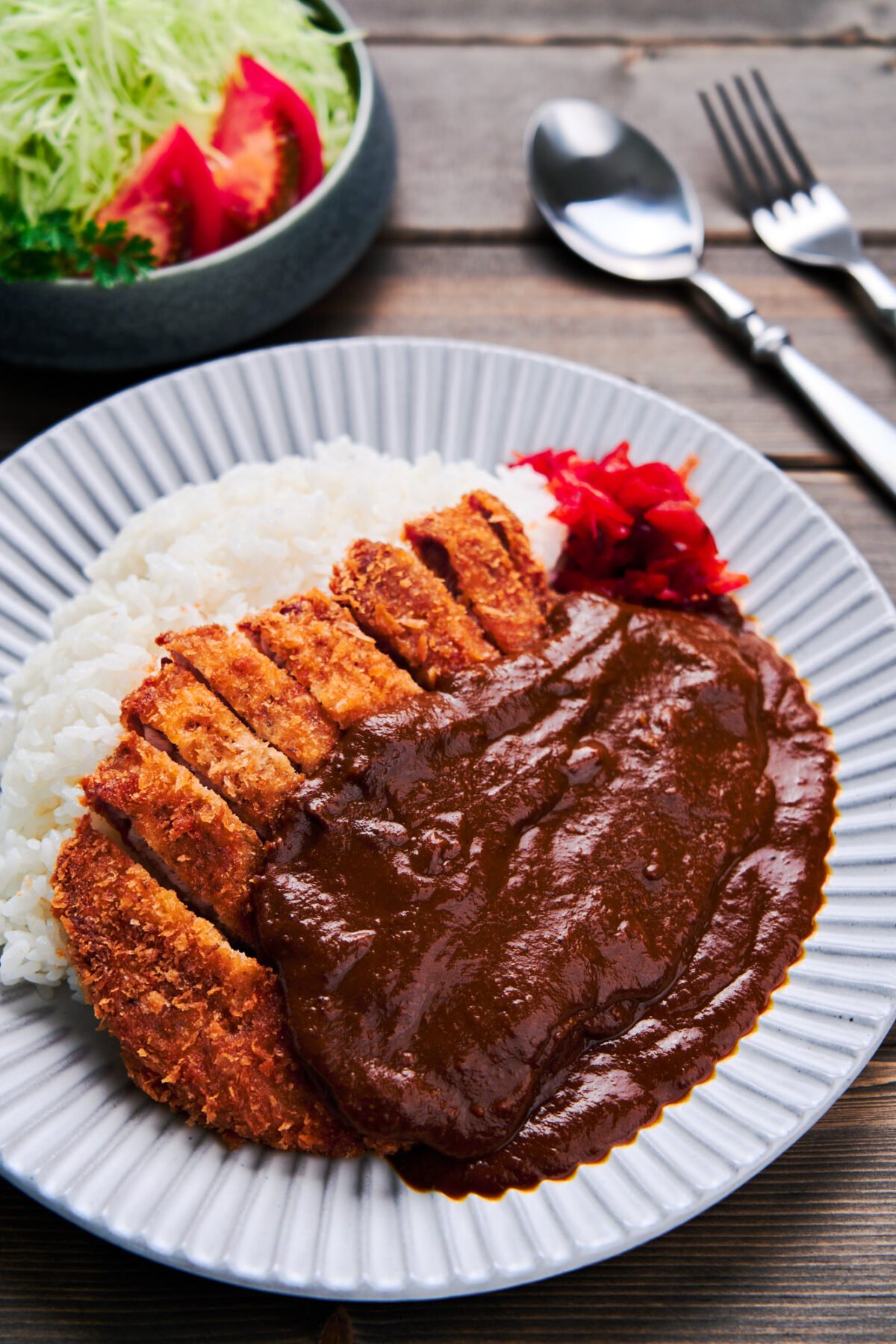 With a crispy pork cutlet draped in a luscious blanket of Japanese curry, this Katsu Curry recipe comes together in under 30 minutes.