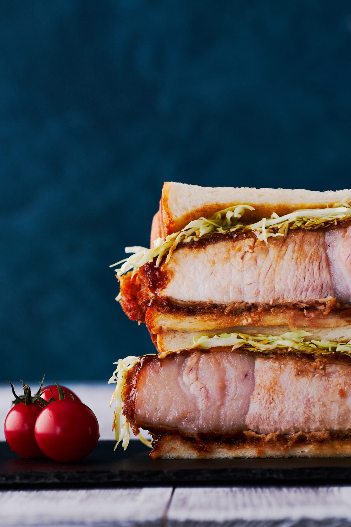 With a thick juicy fried pork cutlet doused in a spiced fruit sauce, stuffed between two slices of fluffy Japanese sandwich bread, Katsu Sandwiches are so good that people are paying hundreds of dollars for them. This easy Katsu Sando recipe will make your stomach smile without breaking the bank.