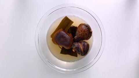 Rehydrating shiitake mushrooms and konbu to make vegan dashi stock.