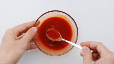 Mixing kimchi pasta sauce.