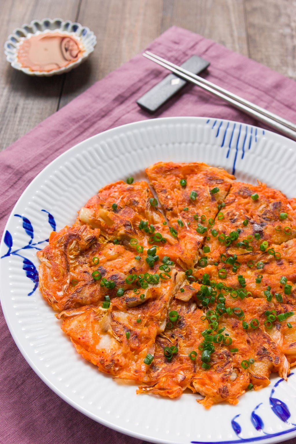 Kimchijeon (Kimchi Pancake) is an easy delicious snack or appetizer made with kimchi, pork and onions that comes together in under 10 minutes.