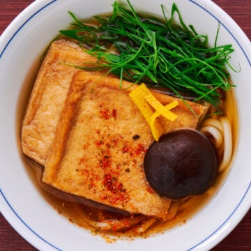 Warm up with a piping hot bowl of Kitsune Udon topped with savory-sweet fried tofu, scallions and yuzu.