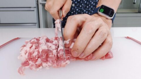 Hand mincing pork for korokke.