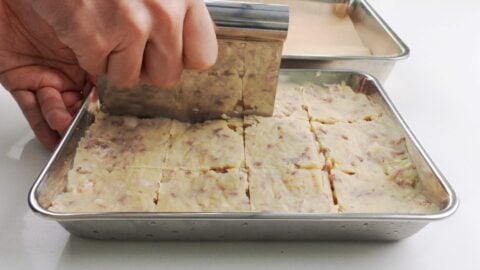 Dividing korokke filling with a pastry knife.