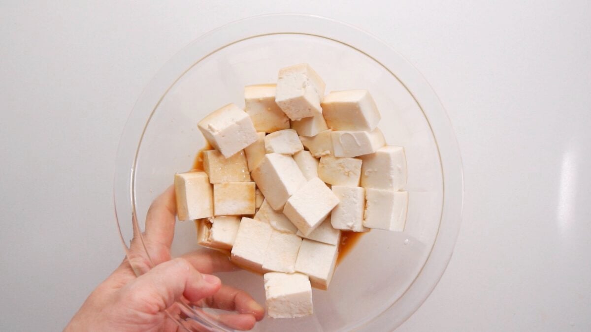 Marinating tofu in glass bowl for Kung Pao Tofu.