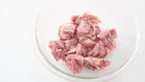 Chicken marinating in bowl for lemon chicken recipe.