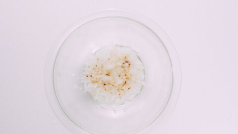 Microwaved onions in a glass bowl for hamburger patty.