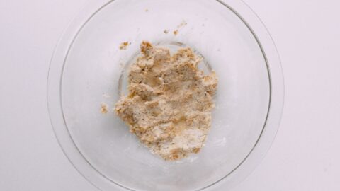 Panko breadcrumbs and cream in a glass bowl.