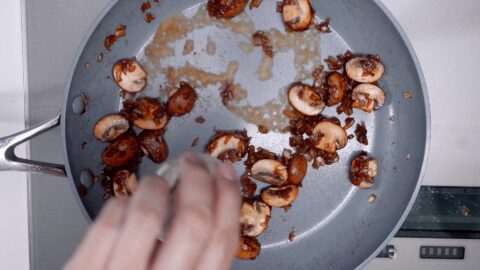 Deglazing the pan with sautéed mushrooms and onions with rum.