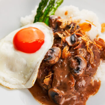 With tender seasoned hamburger patties smothered in pan-gravy, topped with a fried egg and crispy fried onions, Loco Moco is a mouthwatering Hawaiian classic that's easy to make and satisfying.