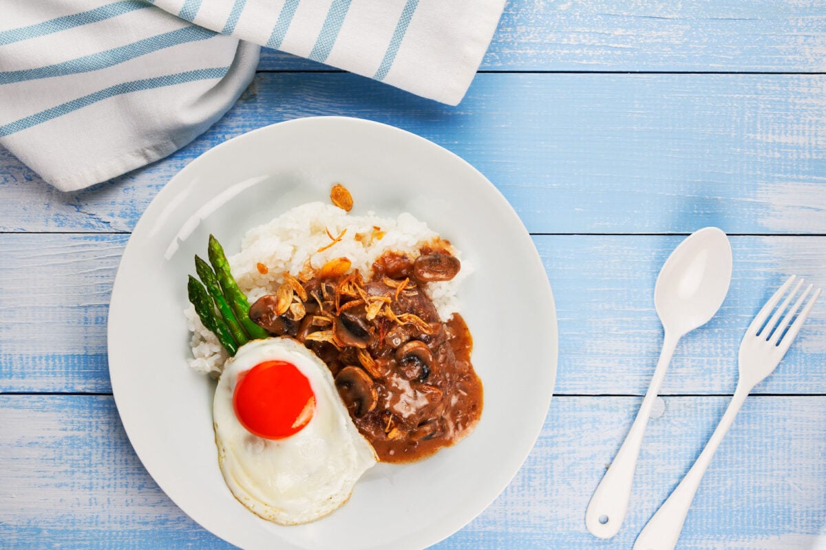 Plate of Hawaiian Hamburger (Loco Moco) with a fried egg, and mushroom gravy on rice.