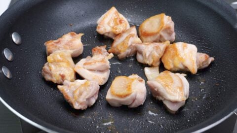 Browned chicken in a frying pan.