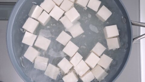 Blanche the tofu in salted water to remove any excess water.