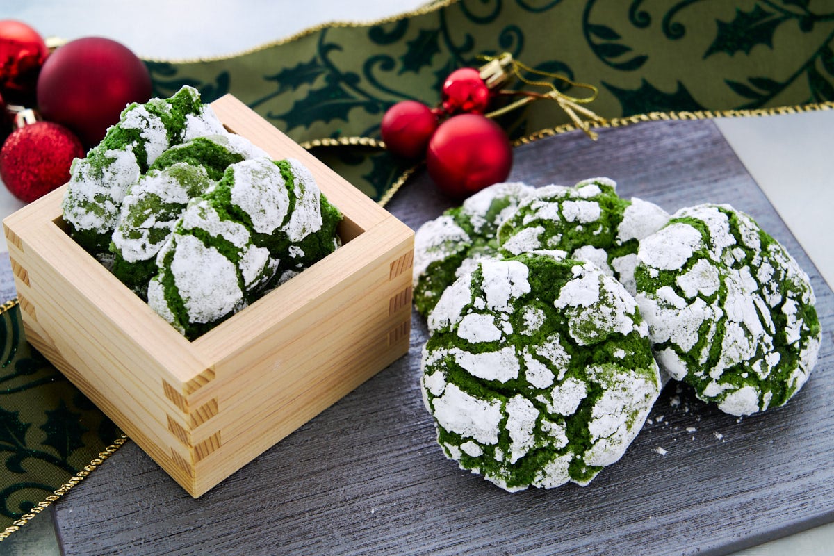 These Matcha Crinkle Cookies have a crisp sugar shell revealing a soft, bittersweet matcha center through emerald green cracks.