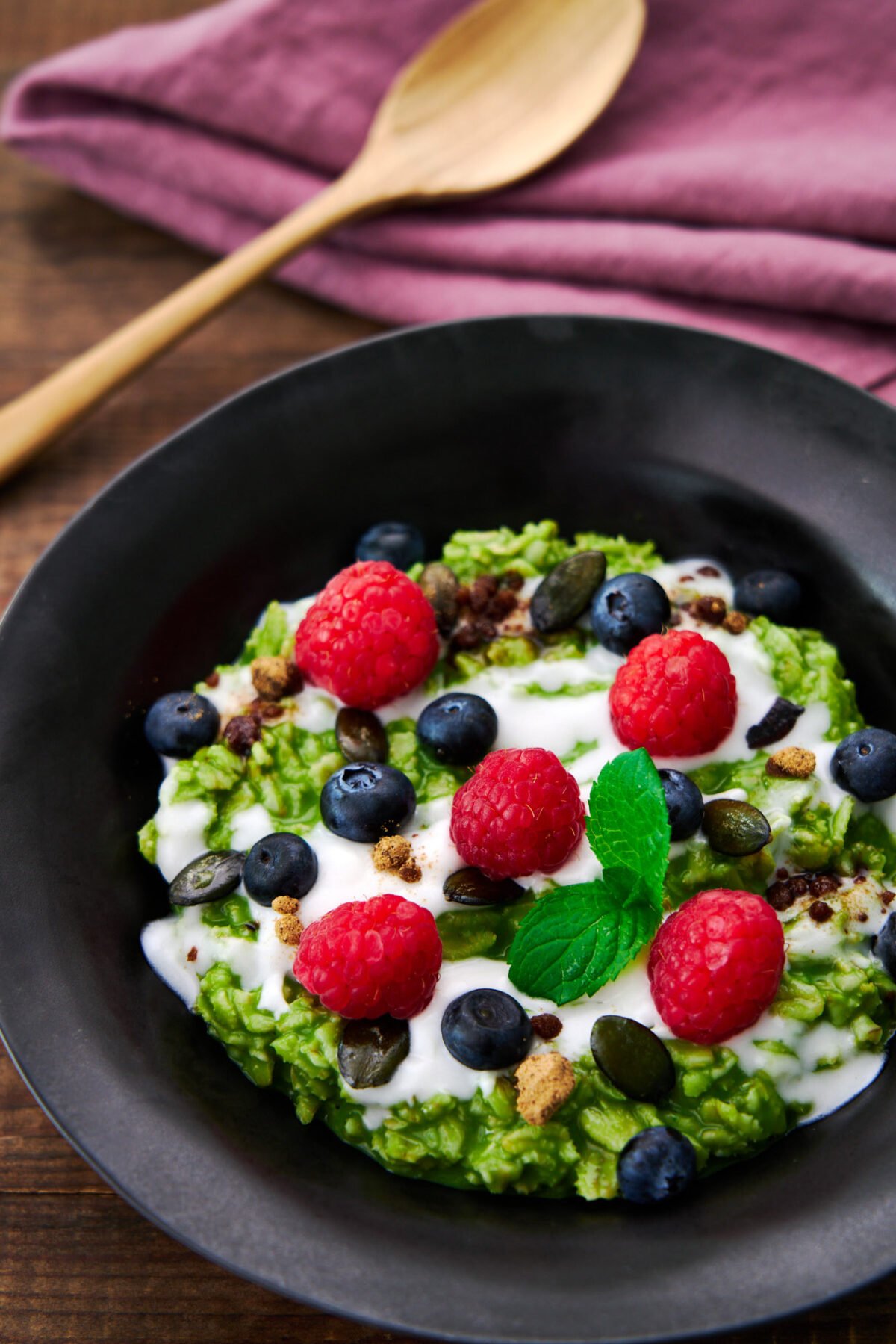 Matcha oatmeal makes for a delicious healthy breakfast with loads of fiber and antioxidents with a kick of caffeine. Topped with coconut cream, fresh berries, and pumpkin seeds.