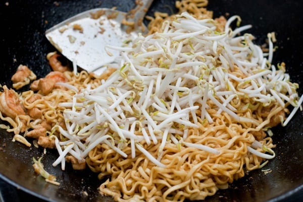 Beansprouts get tossed in a pan of Mie Goreng Java noodles