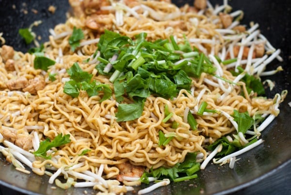 Chinese celery and spring onions garnish the pan of noodles