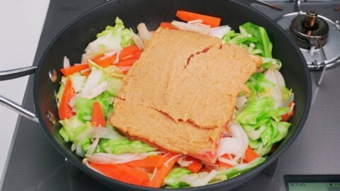 Miso Butter coated salmon on a bed of vegetables.