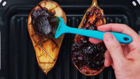 Slathering Dengaku miso glaze onto roasted eggplant.