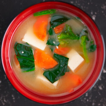 Yellow miso soup recipe with tofu, carrots, and spinach.