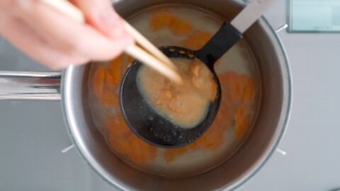 Dissolving yellow miso into miso soup.