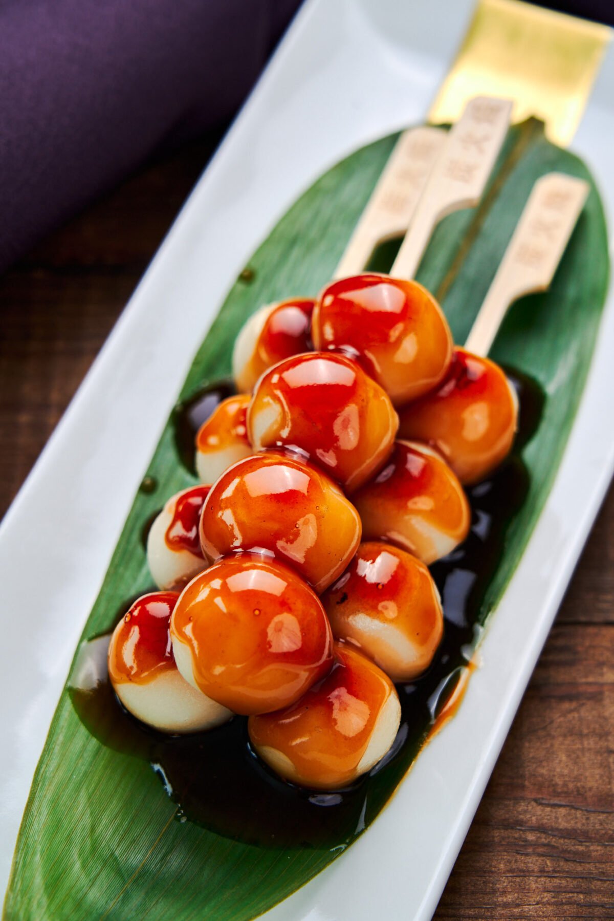 Soft, springy grilled rice dumplings glazed with a sweet and savory sauce. These traditional Japanese Mitarashi Dango make for a delicious snack.