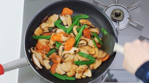 Finish the Moo Goo Gai Pan by adding the sauce and coating all of the ingredients.