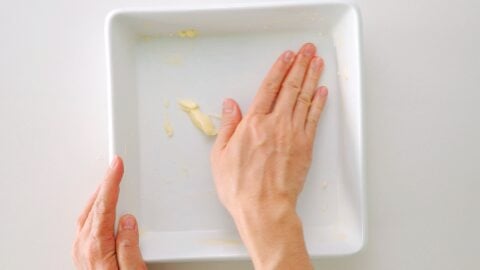 Buttering casserole dish for making Doria.