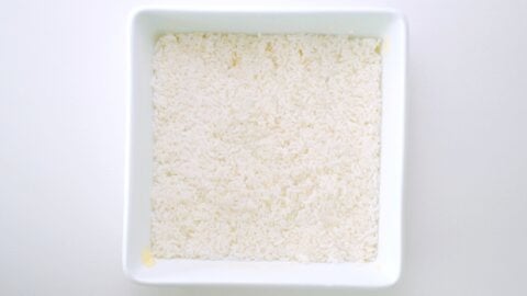 Layer of rice in buttered casserole dish.