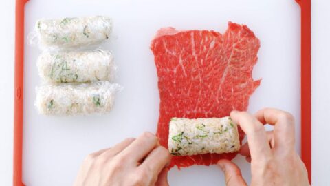 Wrapping onigiri in thin sheets of beef.