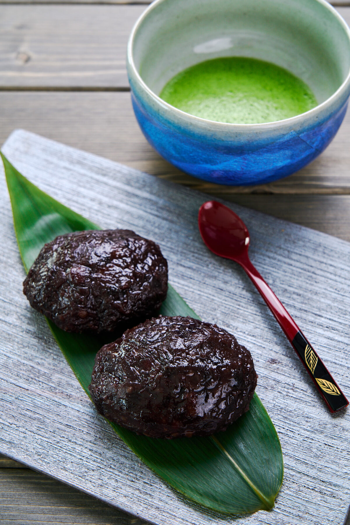 Ohagi or Botamochi is a delicious traditional Japanese dessert made by wrapping sweet rice balls with red bean paste. Shown here with a bowl of matcha.