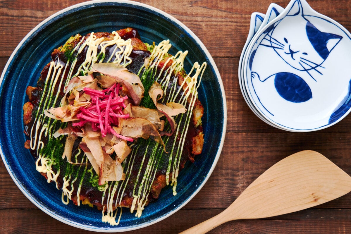 Traditional Osaka-style Okonomiyaki, topped with okonomiyaki sauce, mayonnaise, katsuobushi flakes and red ginger pickles.