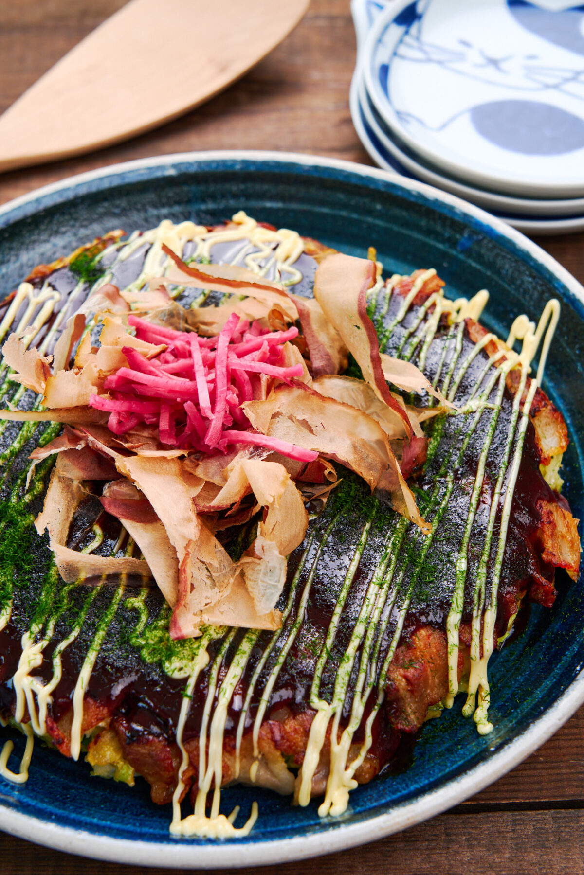 Okonomiyaki is a delicious savory Japanese pancake made with cabbage that can be customized with whatever fillings and toppings you like.