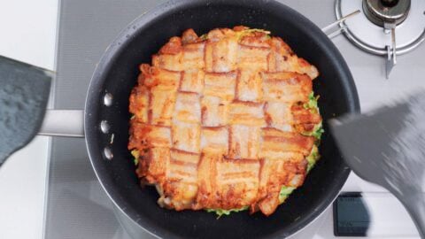 Japanese cabbage pancake topped with crispy pork belly.