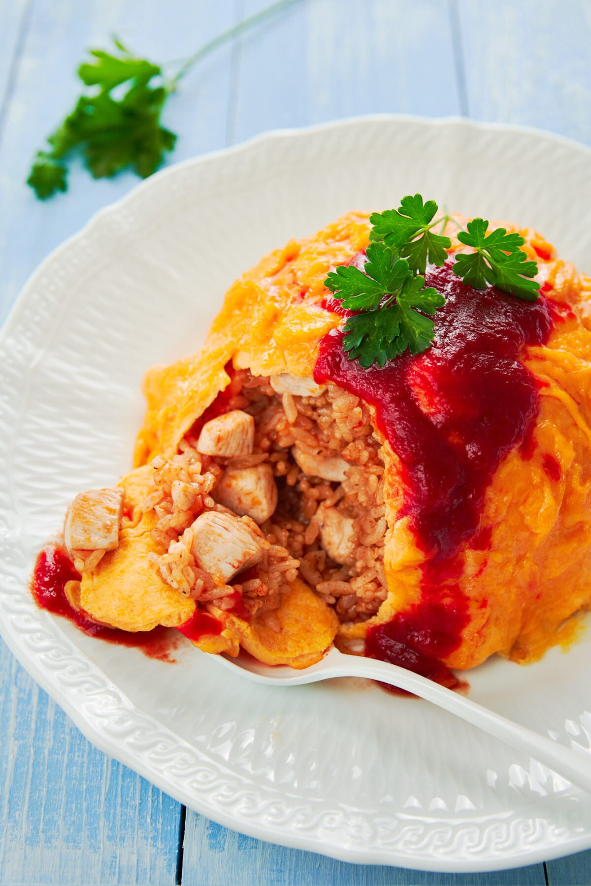 With savory tomato and chicken fried rice enveloped in a fluffy egg omelette, Omurice is a classic Japanese mashup that's loved by kids and grownups alike.