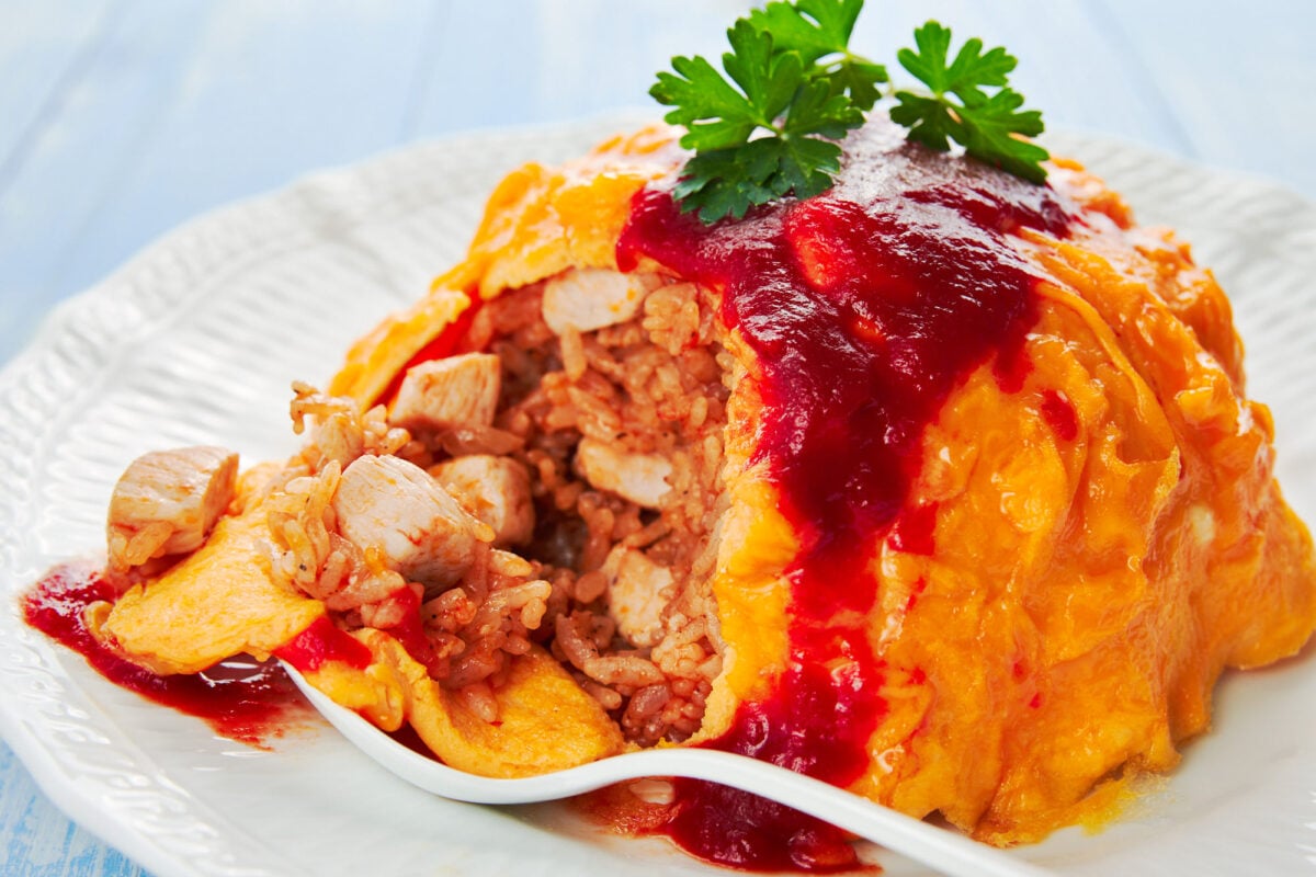 Omurice is a mashup of savory sweet chicken fried rice with a creamy omelette.