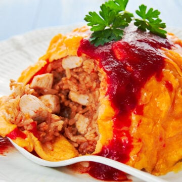 Omurice is a mashup of savory sweet chicken fried rice with a creamy omelette.