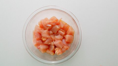 Chicken breast meat marinating in soy sauce.