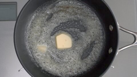 Melting butter in a pan for making an omelette.