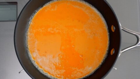 Egg mixture added to buttered omelette pan.