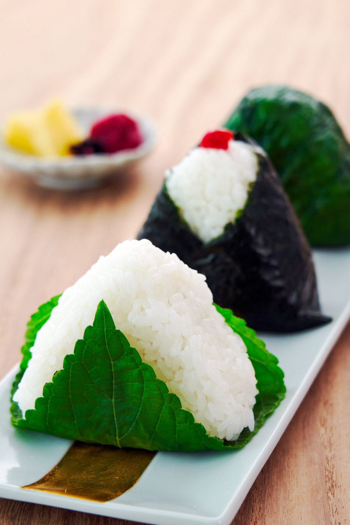 The ultimate guide to making Japanese Rice Balls, or onigiri, and shaping them into perfect triangles without a mold.